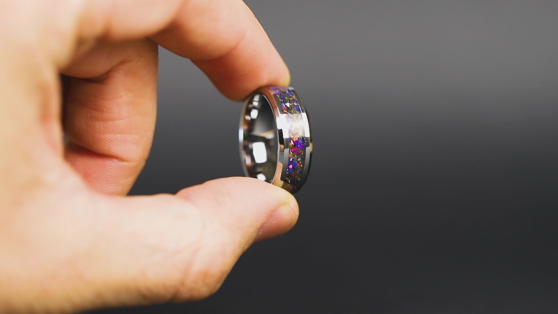 360 degree product view of the Midnight Triceratops ring showing Triceratops bone and Campo del Cielo meteorite shifting through midnight blue purple opal inlay on beveled tungsten band