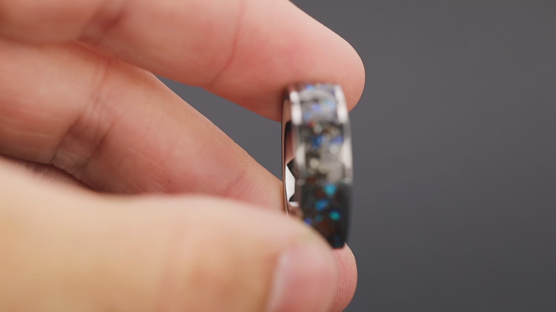 360 degree product view of the Blue Gembone ring showing Dinosaur Gembone and Campo del Cielo meteorite with blue opal accents shifting on 8mm wide channel tungsten band