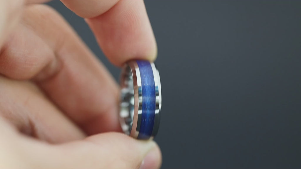 Cinematic view of the Cosmic Ocean ring showing the meteorite sparkle and blue resin.