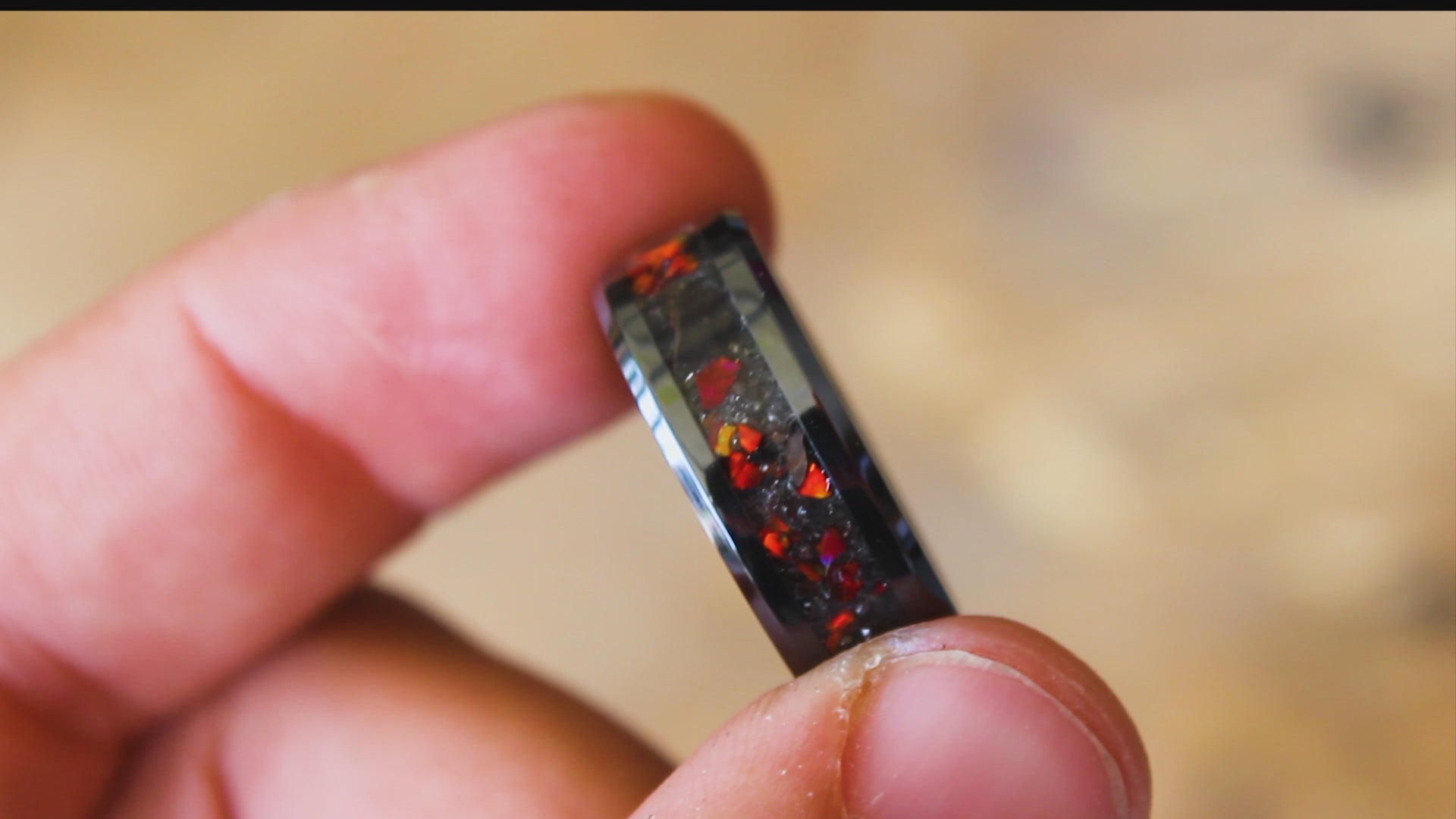 360 degree product view of the Red Rex Ceramic ring showing T-Rex bone and Campo del Cielo meteorite shifting through red opal inlay on 8mm beveled black ceramic band
