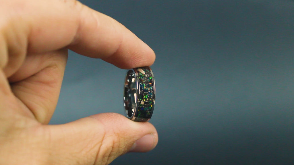 360 degree product view of the Deep Earth ring showing Mosasaur bone, Dinosaur Gembone, and Campo del Cielo meteorite shifting through dark green opal inlay on 8mm wide channel tungsten band