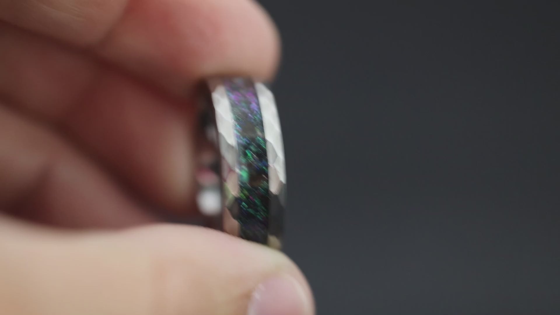 Cinematic view of the Megalodon Nebula ring showing the color-shifting pigment and hammered texture.