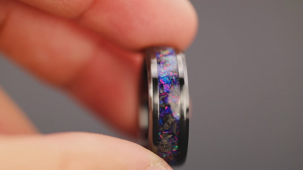 Video of the Lunar Midnight Ceramic handcrafted 8mm beveled black ceramic mens wedding band featuring authentic lunar meteorite, a real piece of the Moon, and proprietary purple blue Midnight Opal inlay