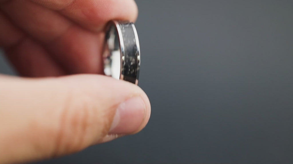 Cinematic view of the Midnight Meteorite ring showing the Gibeon meteorite sparkle and black resin.