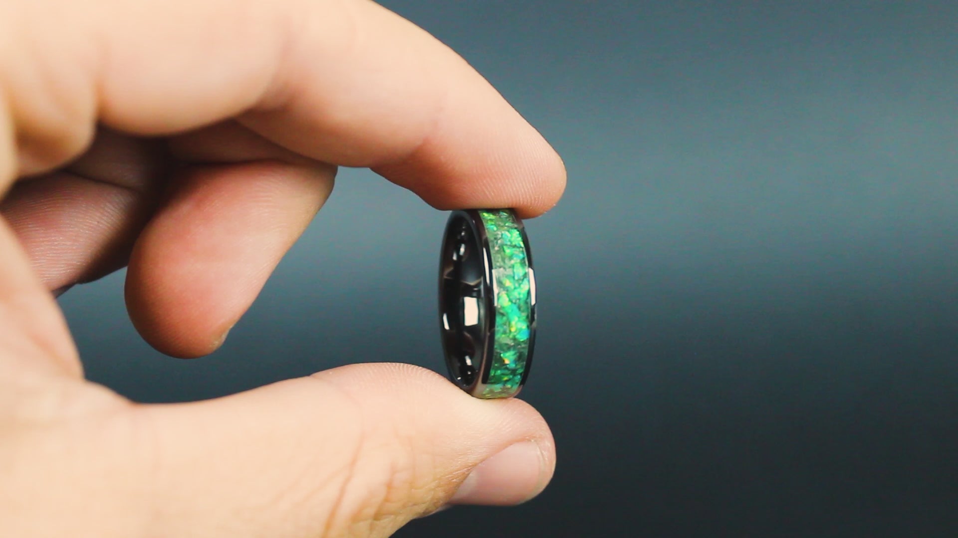 360 degree product view of the Green Orbit Glow ring showing Campo del Cielo meteorite shavings shifting through green opal inlay transitioning to green glow in the dark on wide channel ceramic band