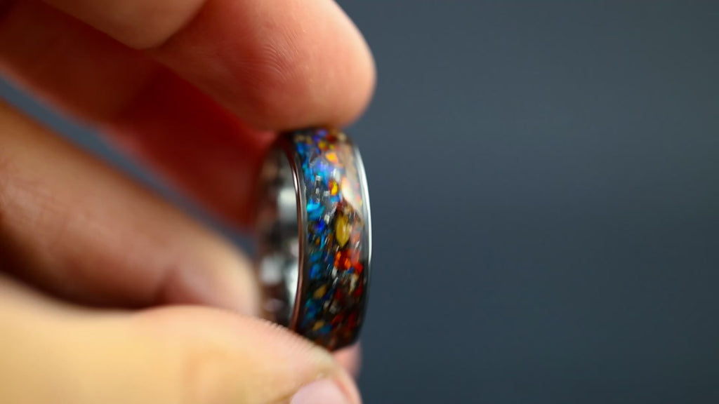 Cinematic view of the Fire and Ice Raptor ring showing the color-shifting red and blue opals.