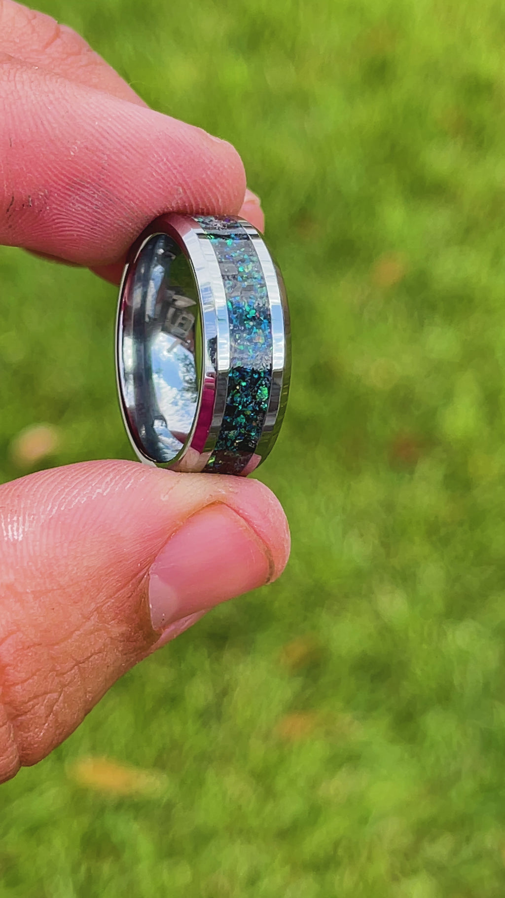 360 degree product view of the Deep Sea Megalodon ring showing Megalodon tooth and Campo del Cielo meteorite shifting through blue and green opal iridescent inlay on 8mm beveled tungsten band