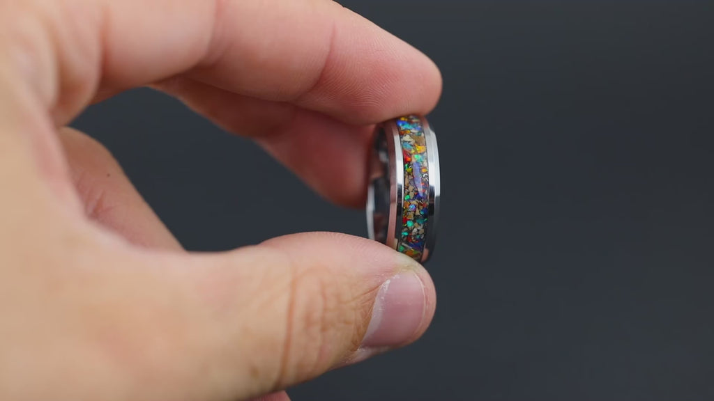 Macro video of The Prehistoric Rainbow ring showing the light-catching glow of rainbow opals and meteorite textures.