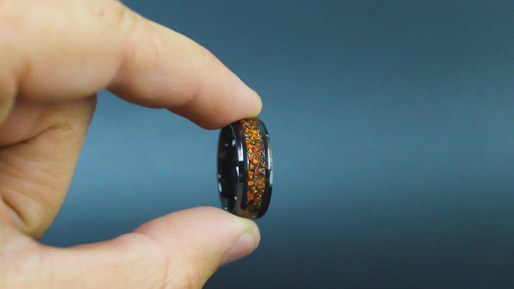 360 degree product view of the Amber Cosmos ring showing Campo del Cielo meteorite shavings shifting through orange opal inlay on 8mm beveled black ceramic band