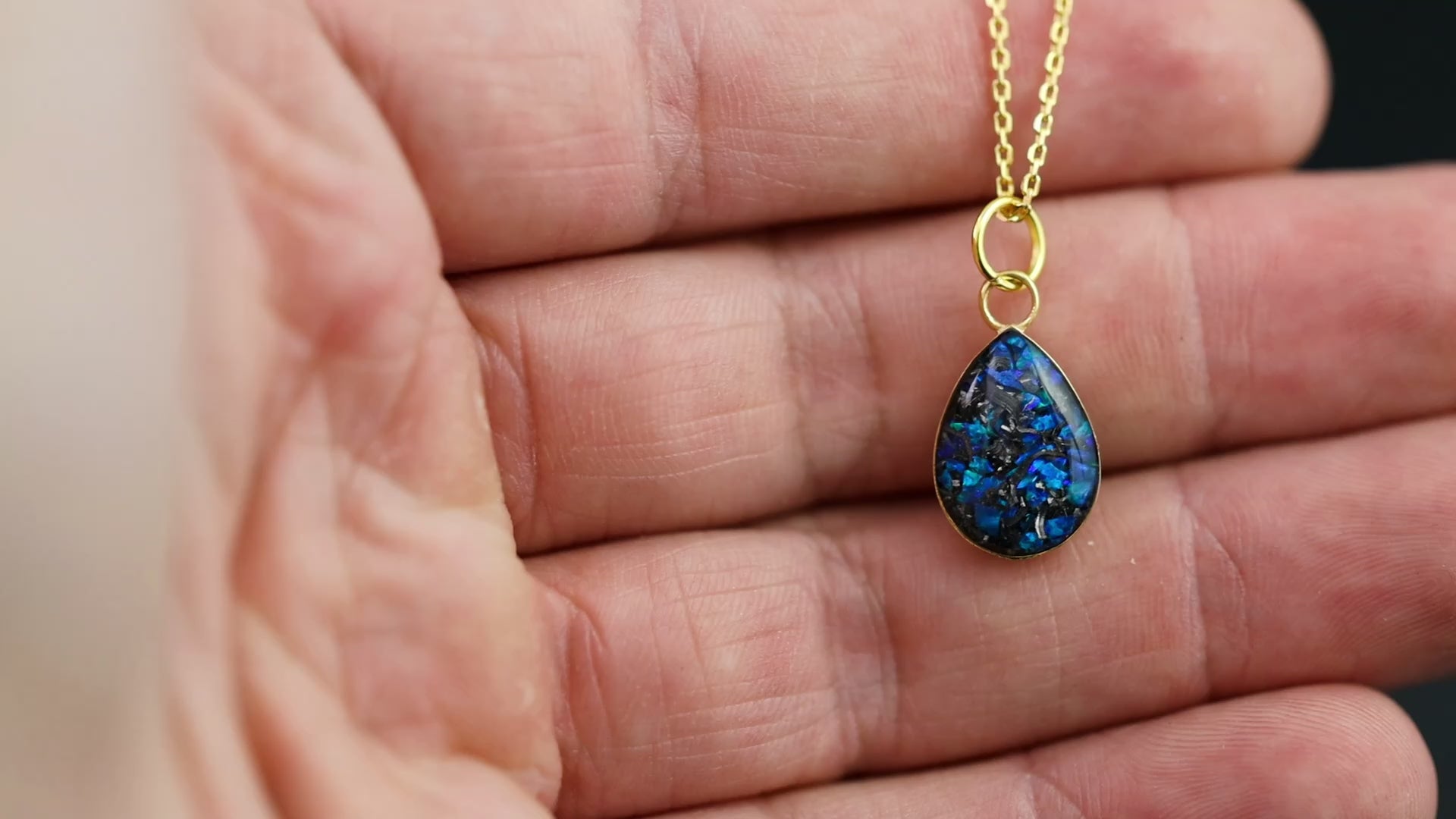 Video of the Sapphire Comet teardrop pendant necklace in gold-plated sterling silver featuring Campo Del Cielo meteorite and blue opal inlay