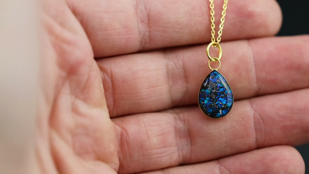 Video of the Sapphire Comet teardrop pendant necklace in gold-plated sterling silver featuring Campo Del Cielo meteorite and blue opal inlay