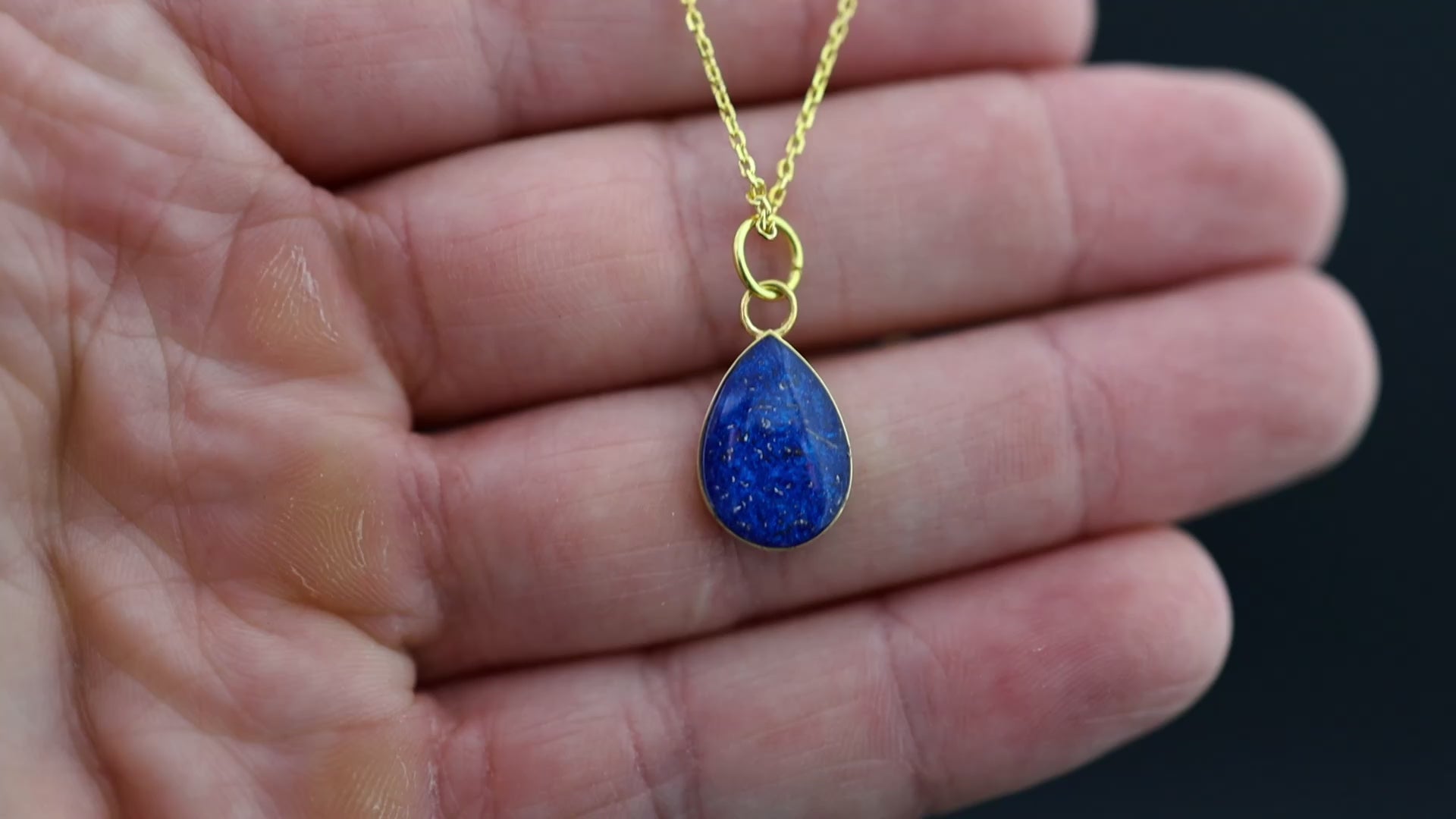 Video of the Cobalt Comet handcrafted blue meteorite necklace in gold-plated sterling silver featuring authentic Campo Del Cielo meteorite and cobalt blue resin inlay