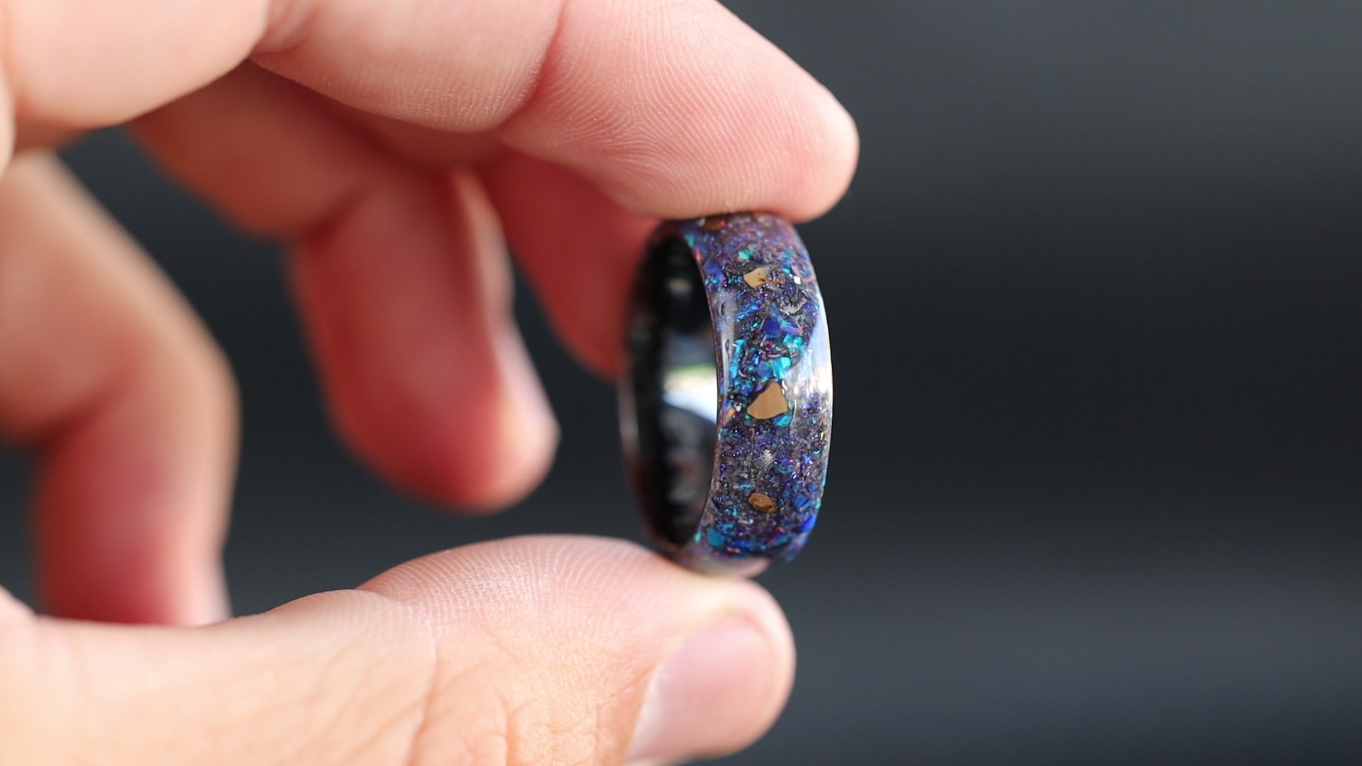 Cinematic view of the silver Midnight Raptor Endless ring showing the bone texture and shifting purple colors.