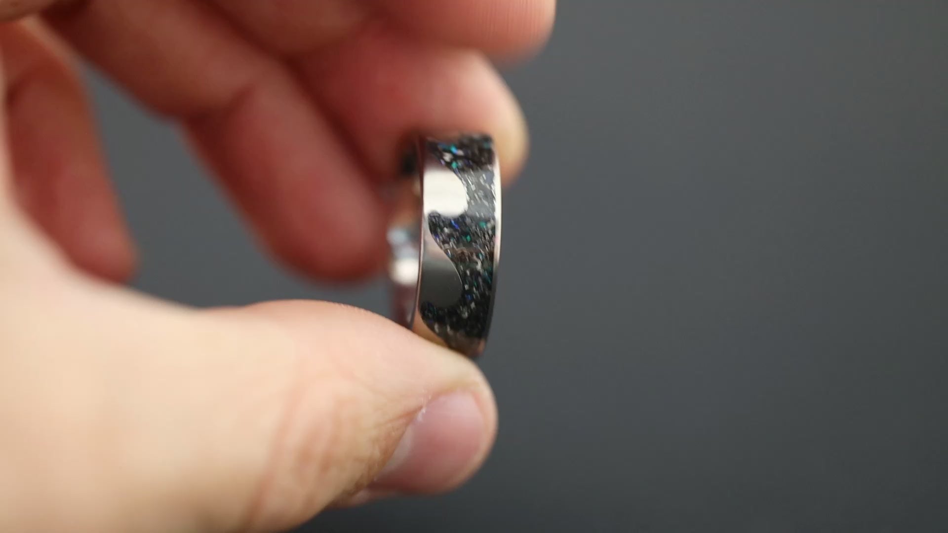 360 degree product view of the Blue Meteorite Riptide ring showing Campo del Cielo meteorite pieces and blue opal accents in wave-shaped cutout on 8mm titanium riptide band