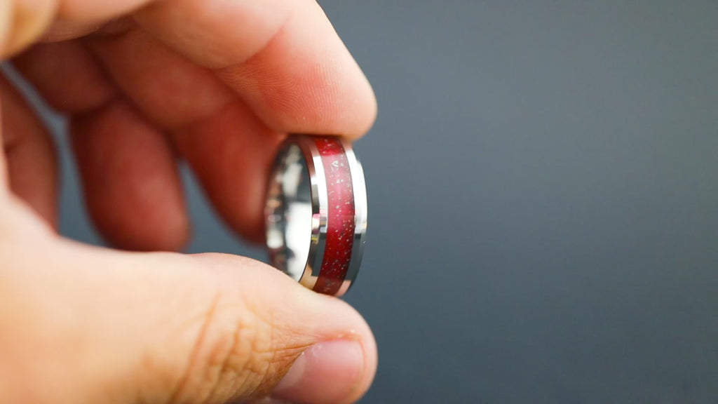Cinematic view of the Crimson Impact ring showing the meteorite sparkle and red resin.