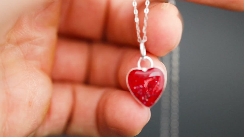 Video of the Cherry Pulse handcrafted red heart necklace in sterling silver featuring authentic Campo Del Cielo meteorite and deep cherry red resin inlay