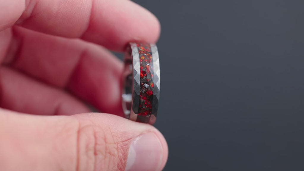 Cinematic 360-degree view of the Apex Ember T-Rex bone and meteorite ring showing the red opal glow and hammered finish.