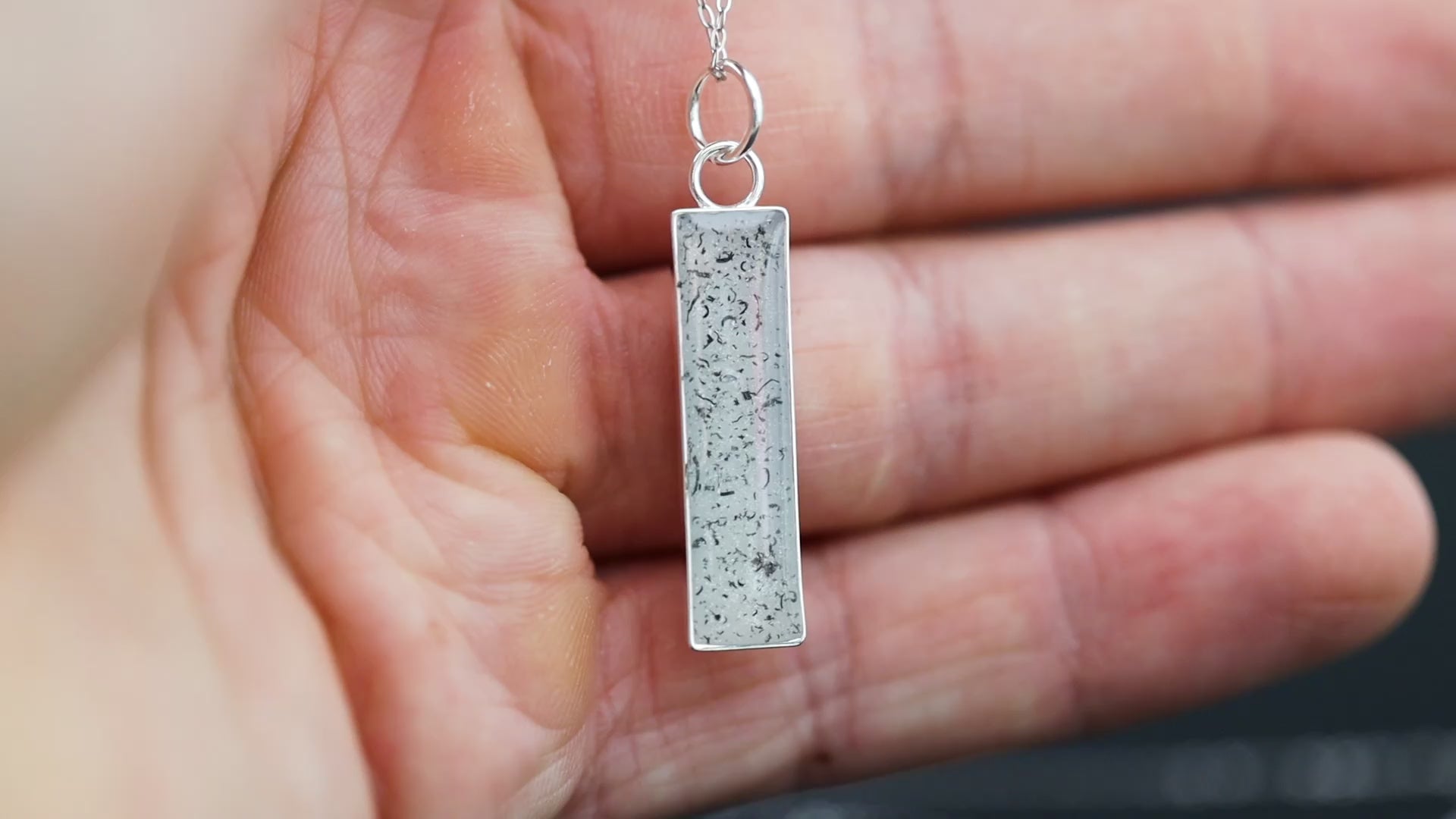 Video of the Polar Nova handcrafted white bar necklace in sterling silver featuring authentic Campo Del Cielo meteorite and clean white resin inlay