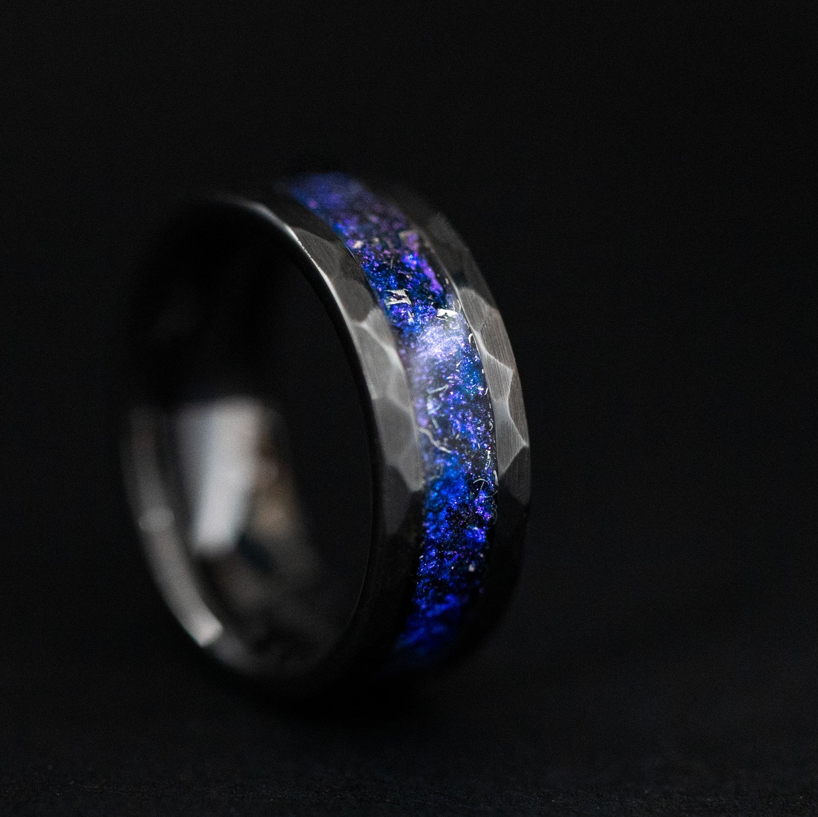 hammered black ceramic wedding band featuring celestial meteorite fragments and twilight shimmer.