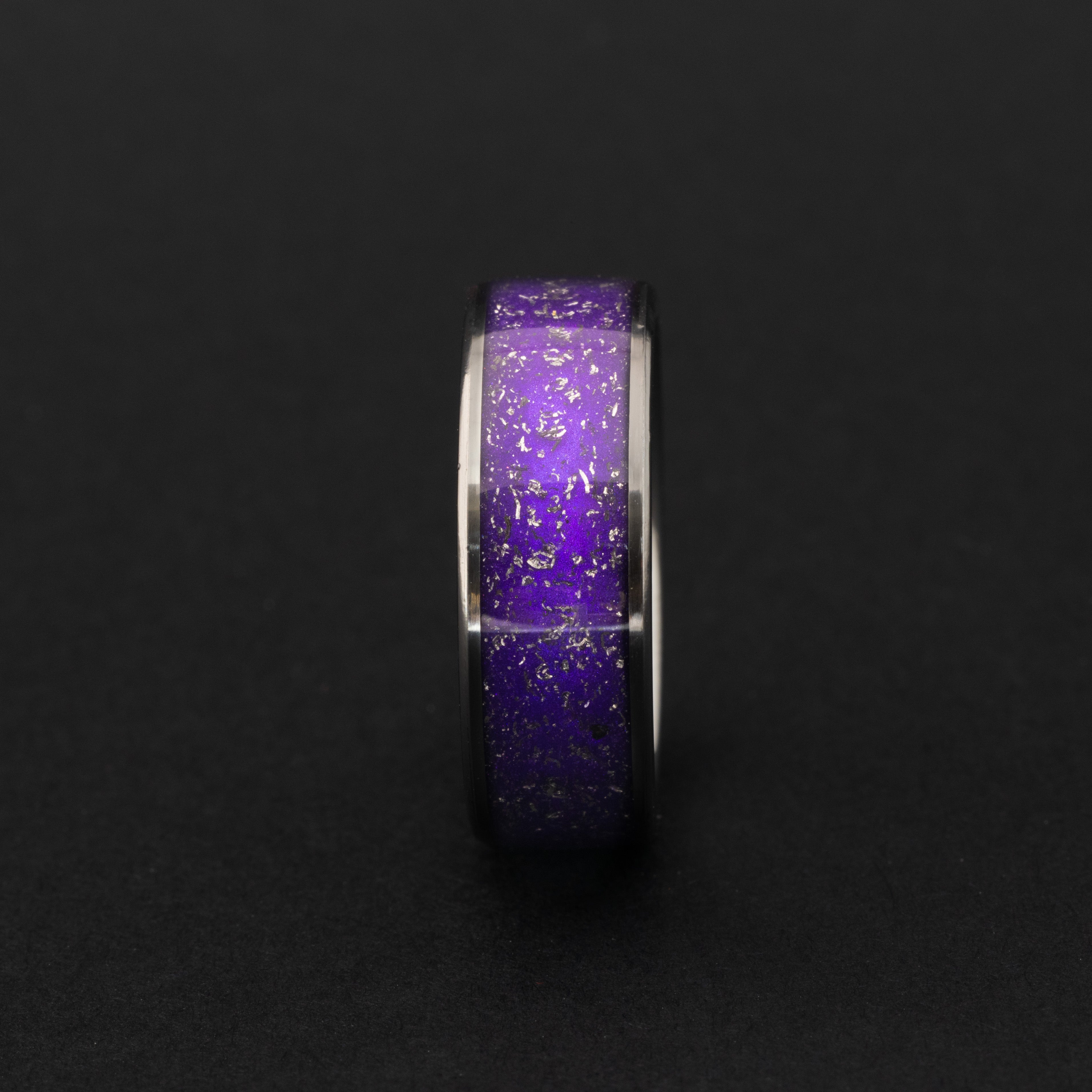 Close up of Gibeon meteorite shavings in a vibrant purple 8mm tungsten ring.