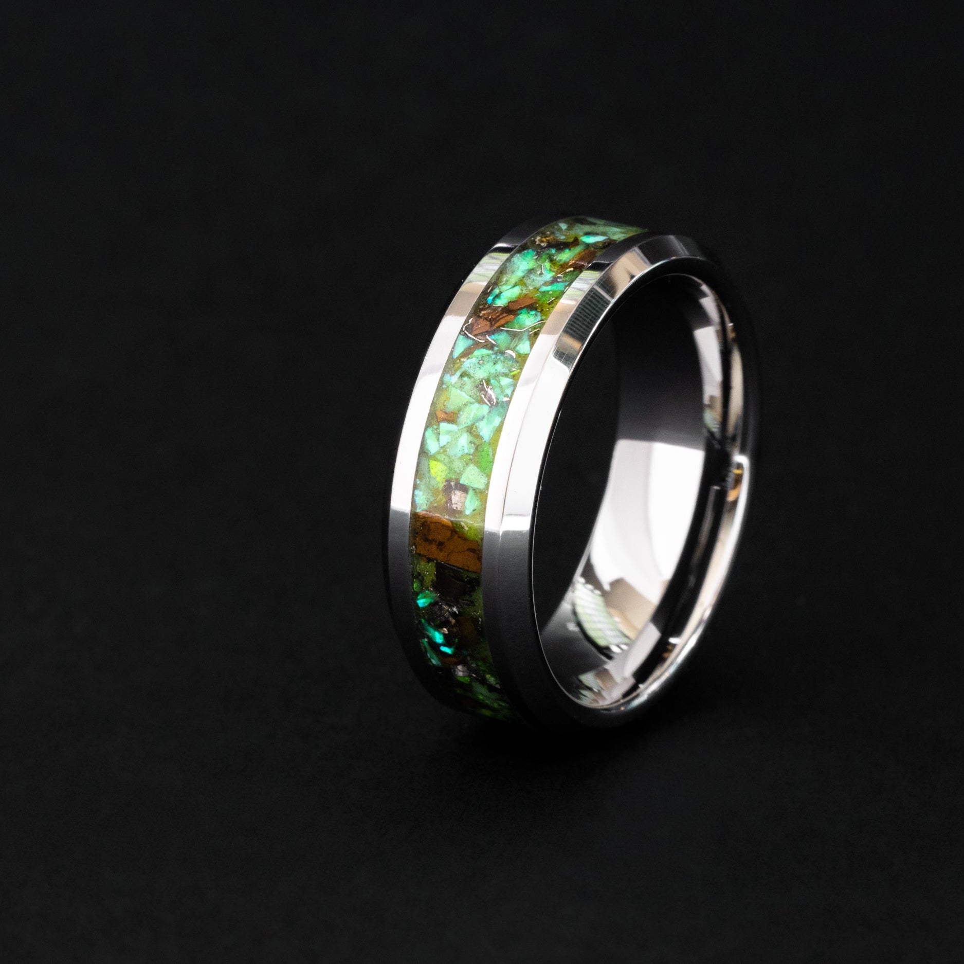 8mm beveled silver tungsten ring with authentic Velociraptor bone, meteorite, and neon green glow inlay.