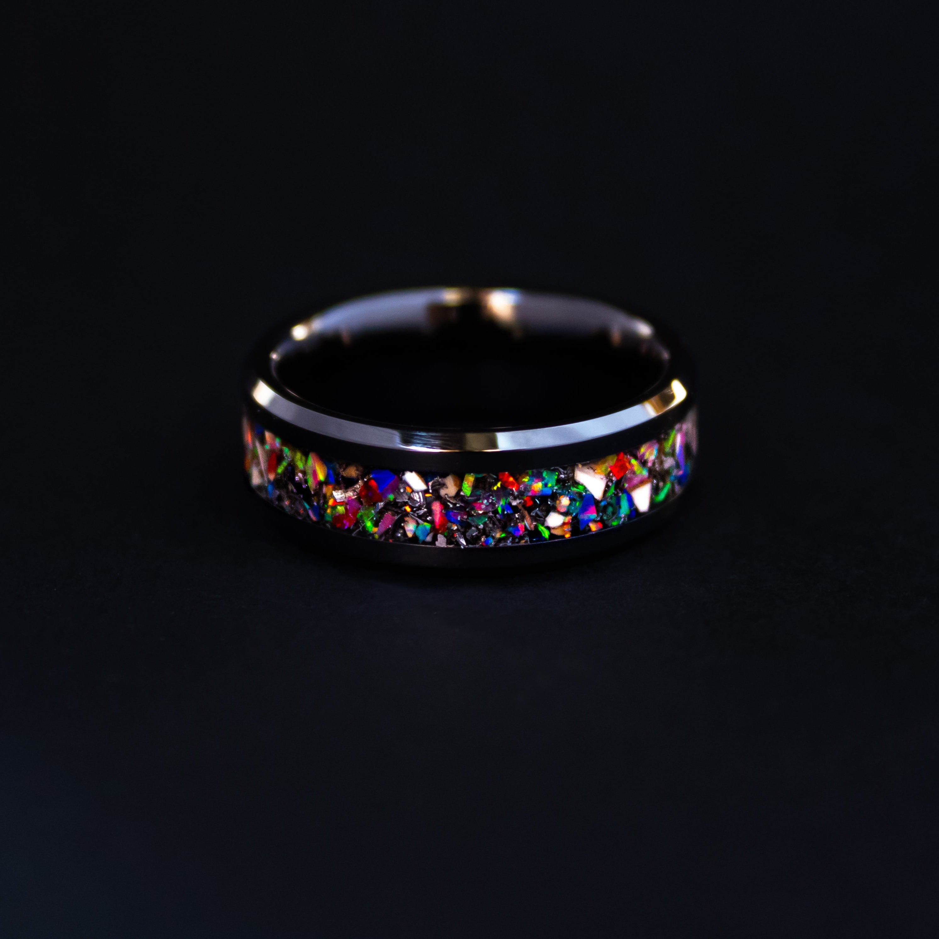 8mm beveled black ceramic ring with authentic Mosasaur bone and red orange green blue purple pink opal inlay