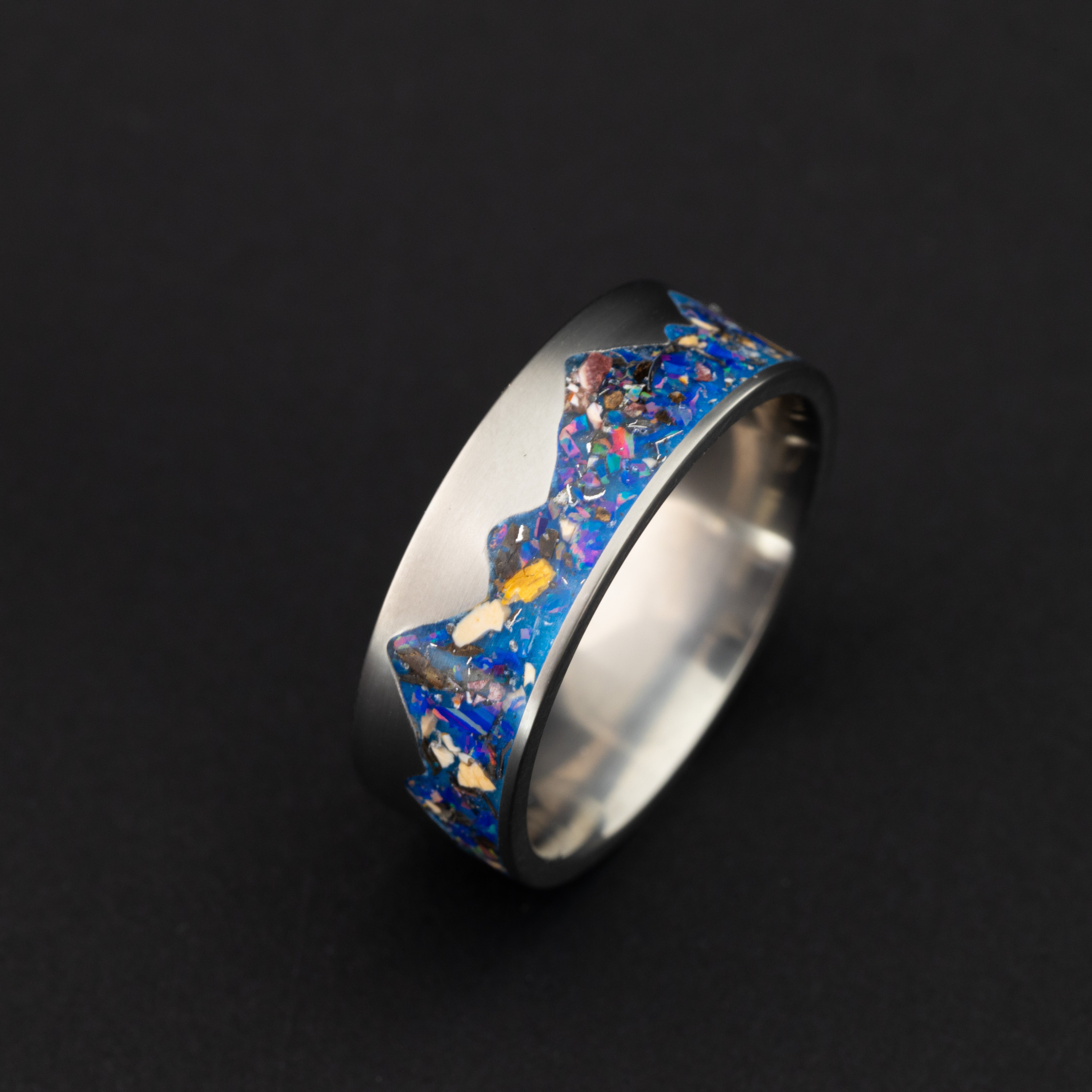 Side profile of the handcrafted titanium Raptor Ridgeline ring with opal inlay made in a California studio.