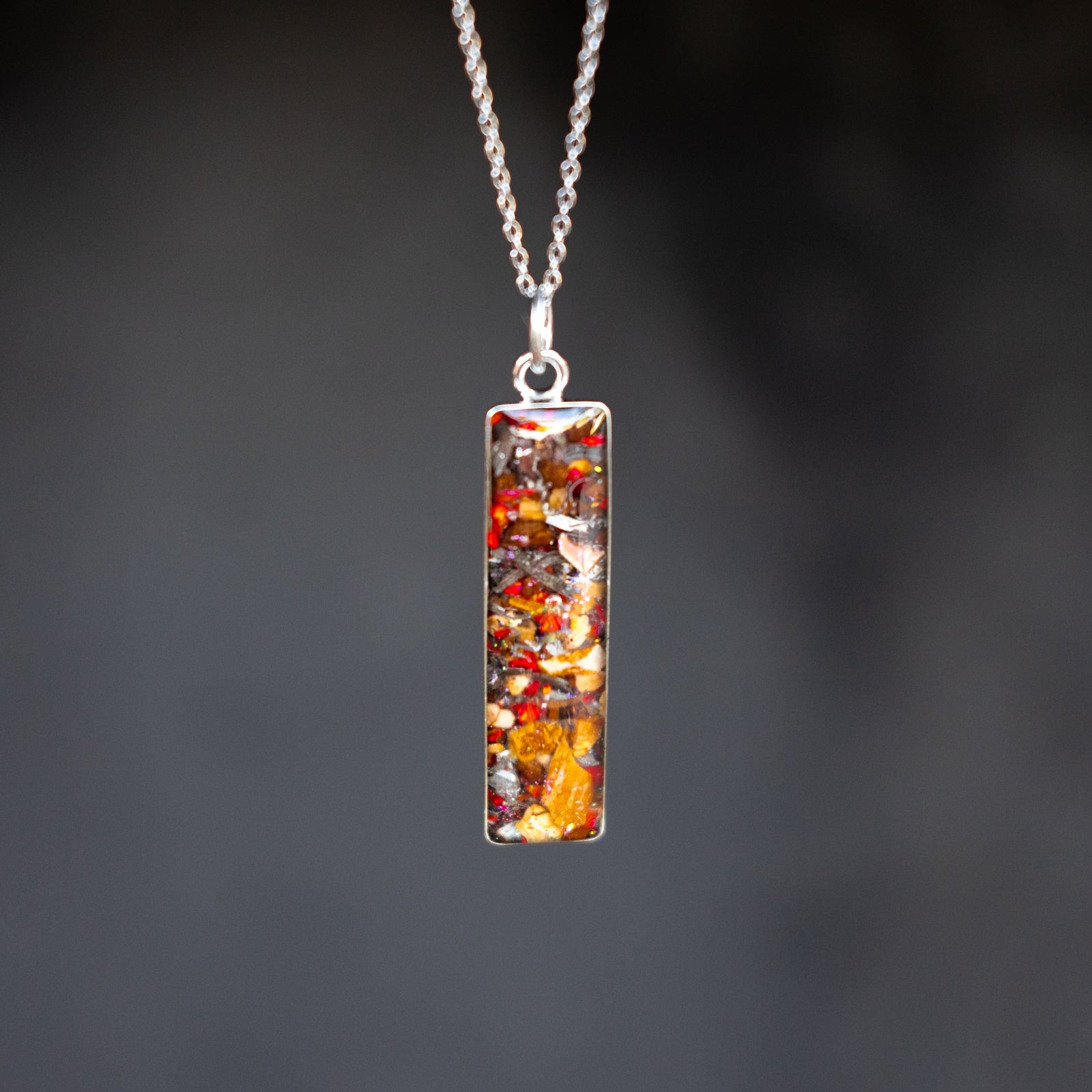 Ruby Velociraptor authentic silver bar pendant necklace with Campo Del Cielo meteorite, real velociraptor fossil bone, and red opal inlay