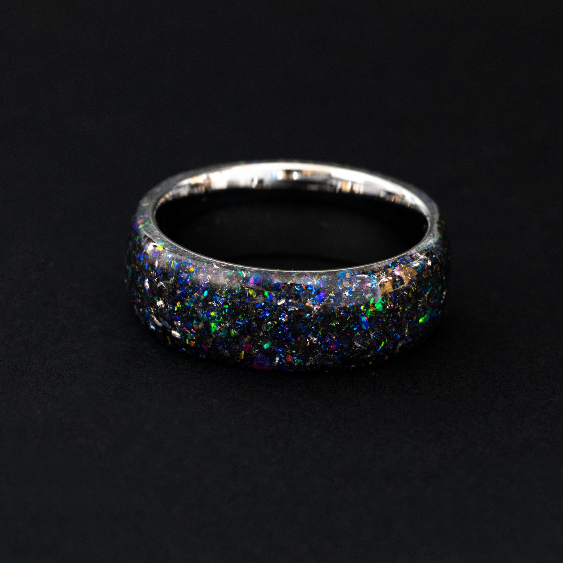endless silver tungsten wedding band featuring celestial meteorite fragments and purple shimmer.