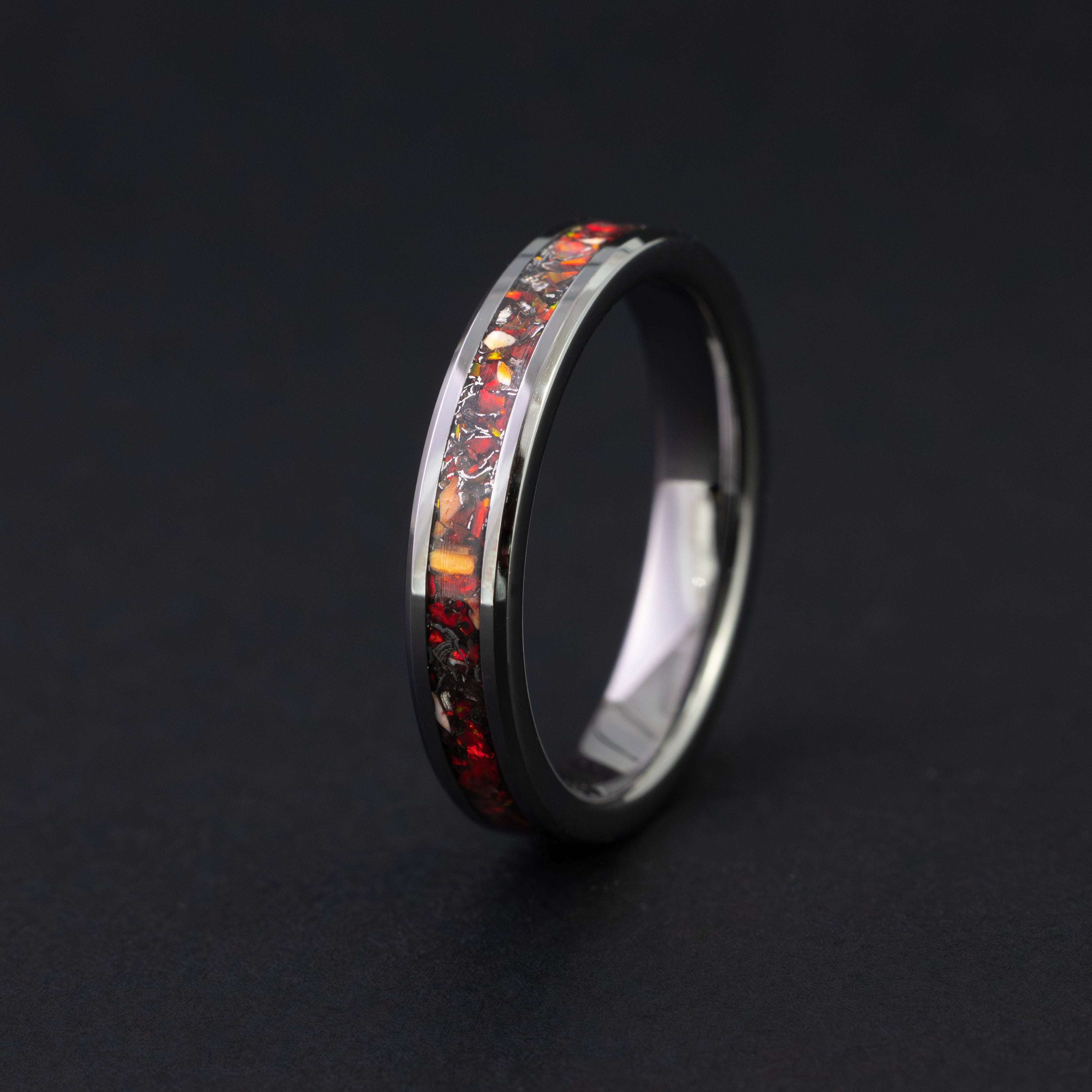 Sleek 4mm black ceramic ring with Velociraptor bone and red fire opal inlay.