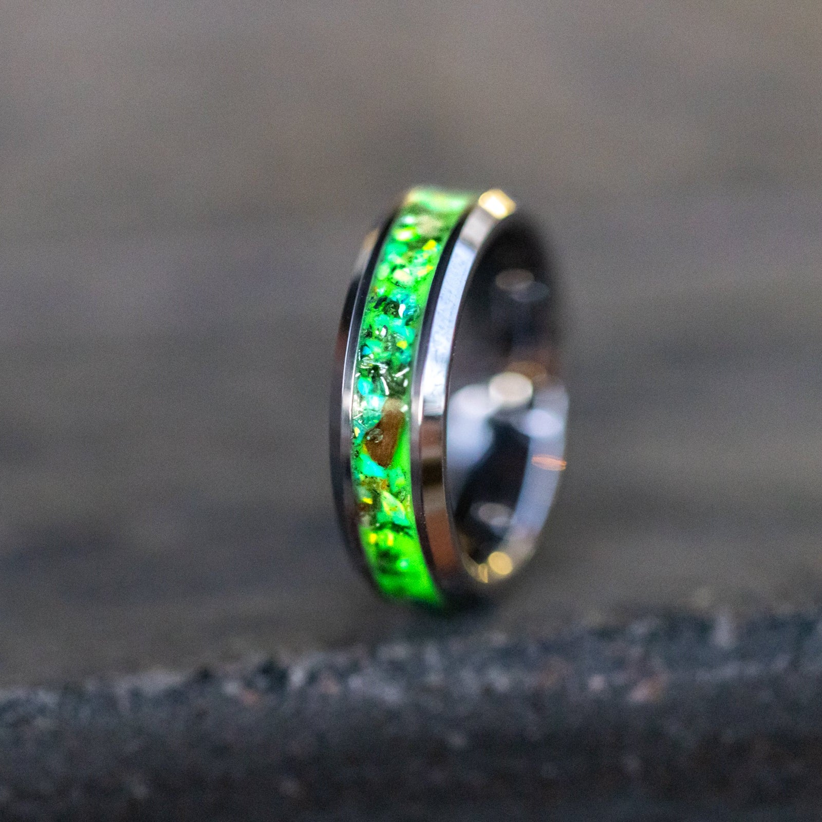 6mm tungsten ring with authentic Velociraptor bone and Campo del Cielo meteorite in lime green opal inlay glowing green in the dark