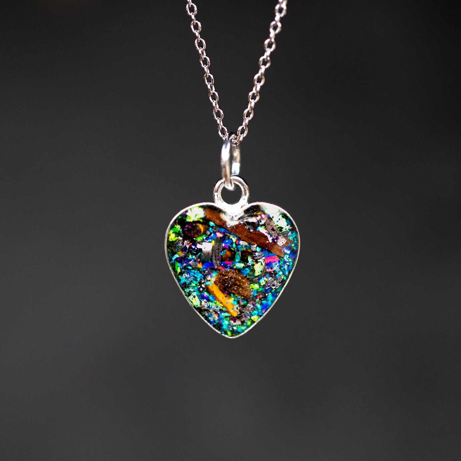 Shop the TRex and Raptor Heart authentic silver meteorite, real T-Rex and velociraptor bone heart pendant necklace. Handcrafted gothic dinosaur fossil necklace from California.