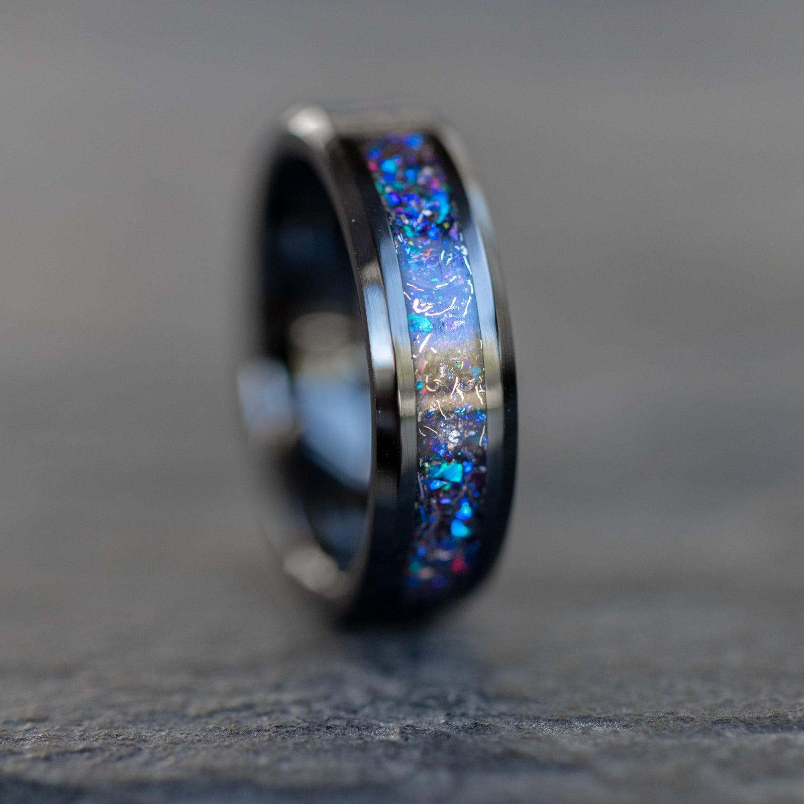 Detail shot of the Twilight Meteor ring showing authentic Campo del Cielo meteorite shavings catching light through blue and purple opal galaxy inlay