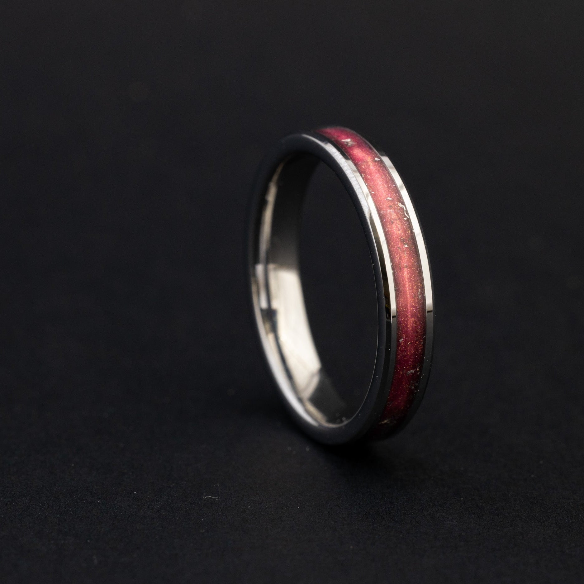 Handcrafted 4mm tungsten wedding band featuring celestial meteorite fragments and metallic pink inlay.
