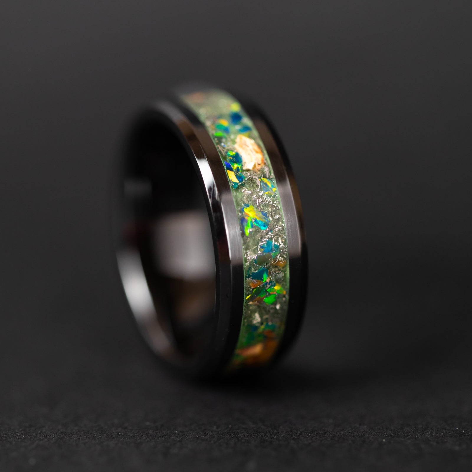 Handcrafted 8mm beveled black ceramic mens wedding band with authentic Velociraptor bone and Campo del Cielo meteorite in green opal green glow inlay made in California
