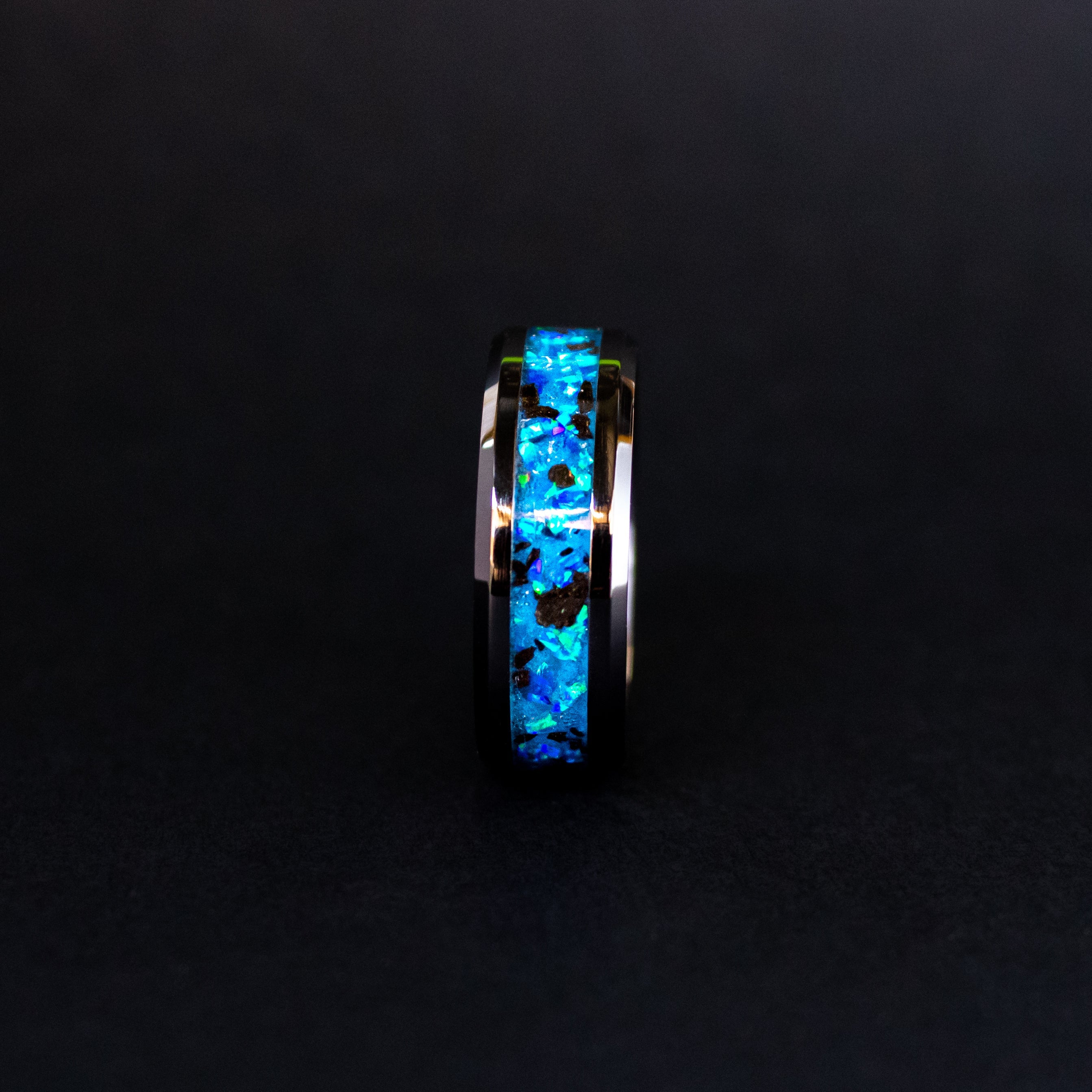 Handcrafted 8mm beveled black ceramic mens wedding band with authentic Megalodon tooth in blue opal blue glow inlay made in California