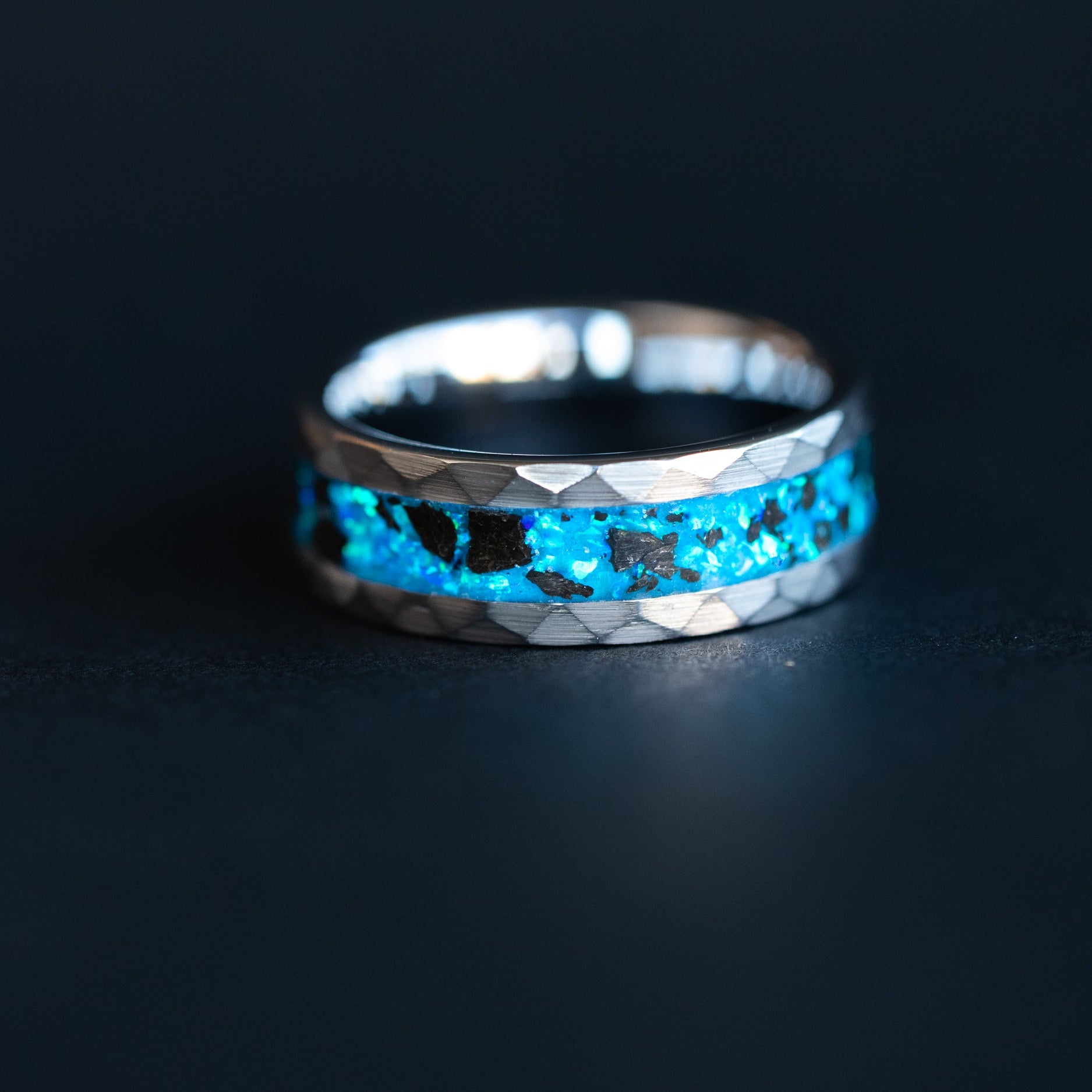 Handcrafted 8mm hammered tungsten mens wedding band with authentic Megalodon tooth fossil and blue glow in the dark opal inlay made in California