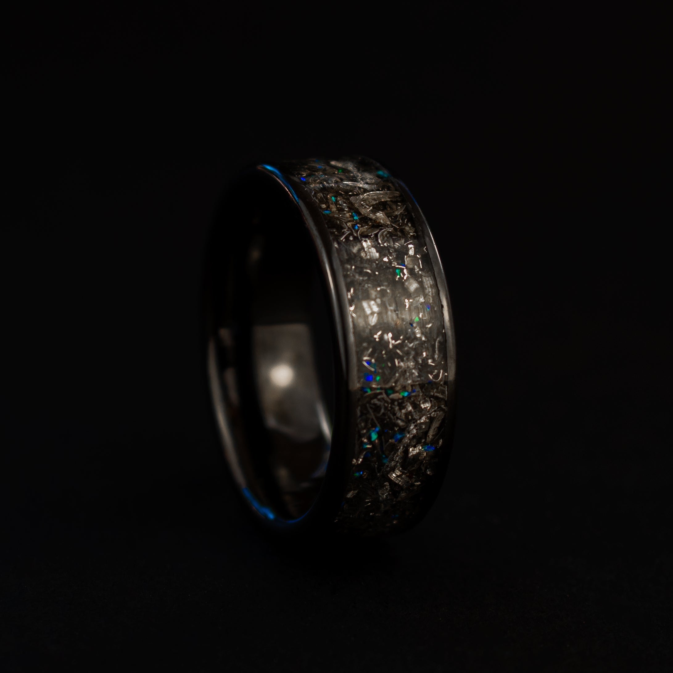 Handcrafted 8mm wide channel black ceramic mens wedding band with authentic Campo del Cielo meteorite and blue opal accents made in California