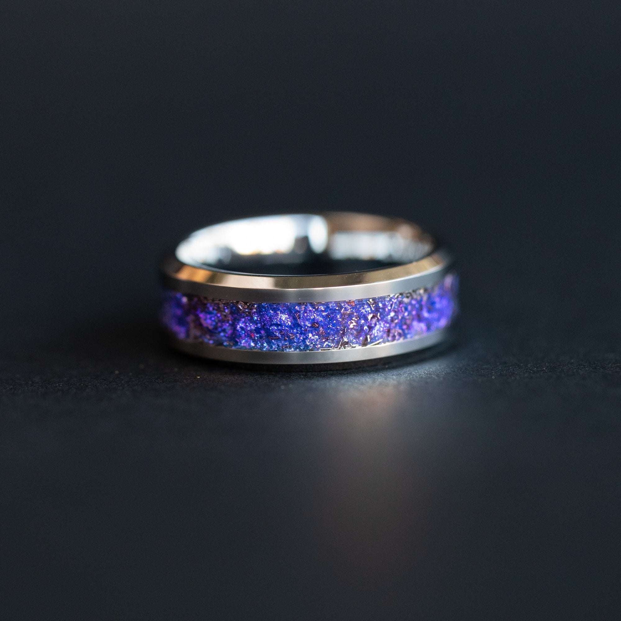 Handcrafted 8mm beveled tungsten mens wedding band with authentic Campo del Cielo meteorite and deep purple blue midnight galaxy pigment inlay made in California