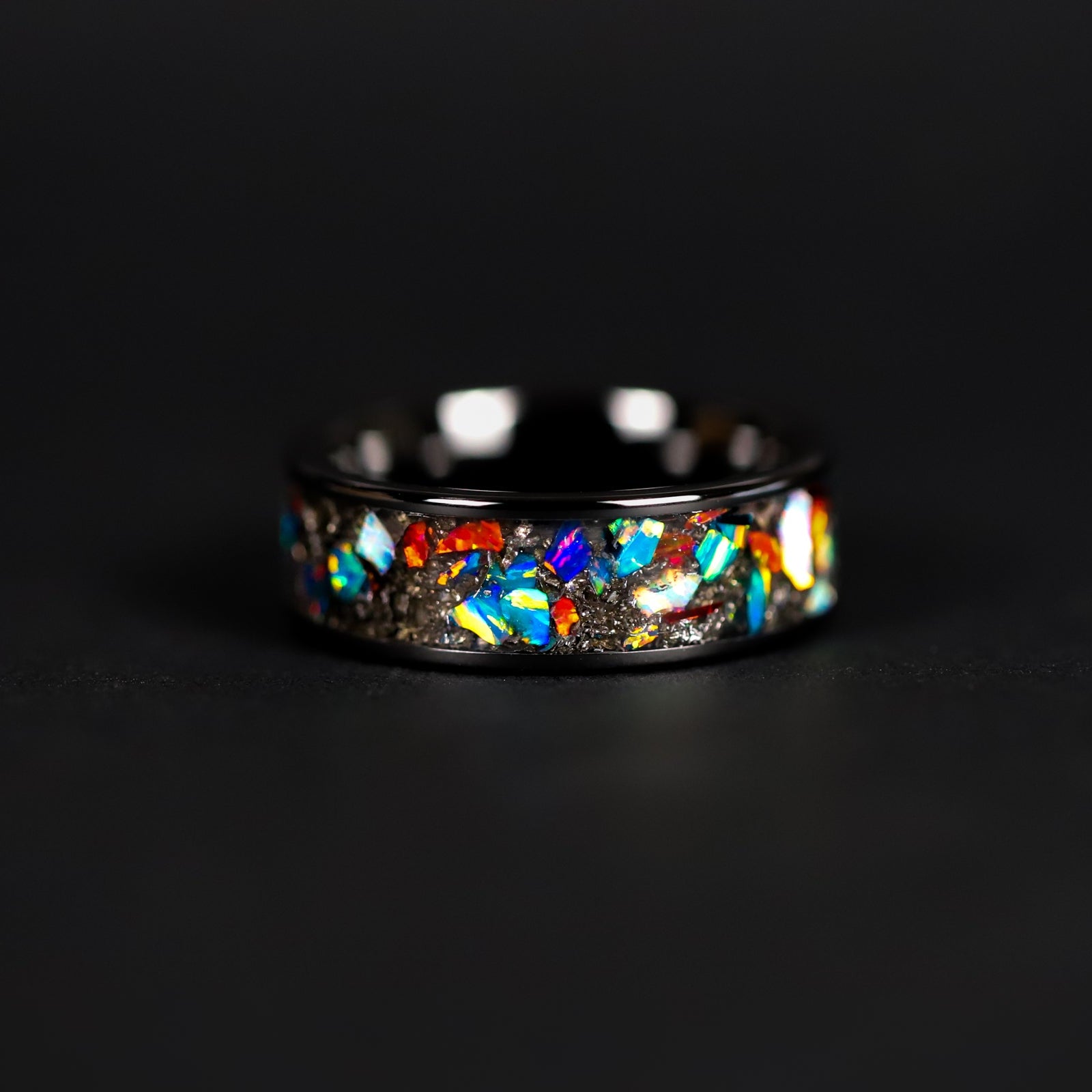 Handcrafted 8mm wide channel black ceramic mens wedding band with authentic Campo del Cielo meteorite and multi-color opal mosaic inlay made in California