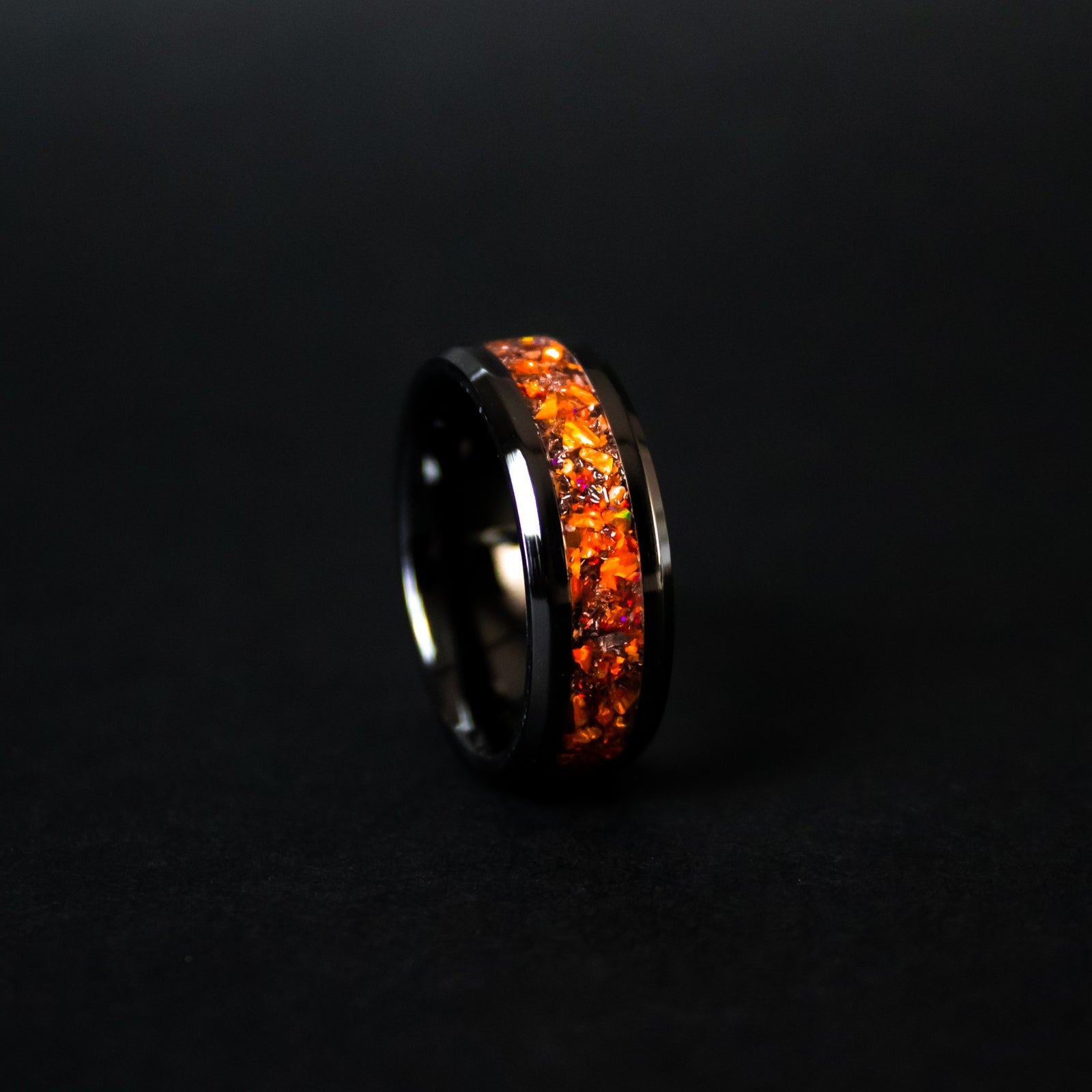 Handcrafted 8mm beveled black ceramic mens wedding band with authentic Campo del Cielo meteorite in orange opal inlay made in California