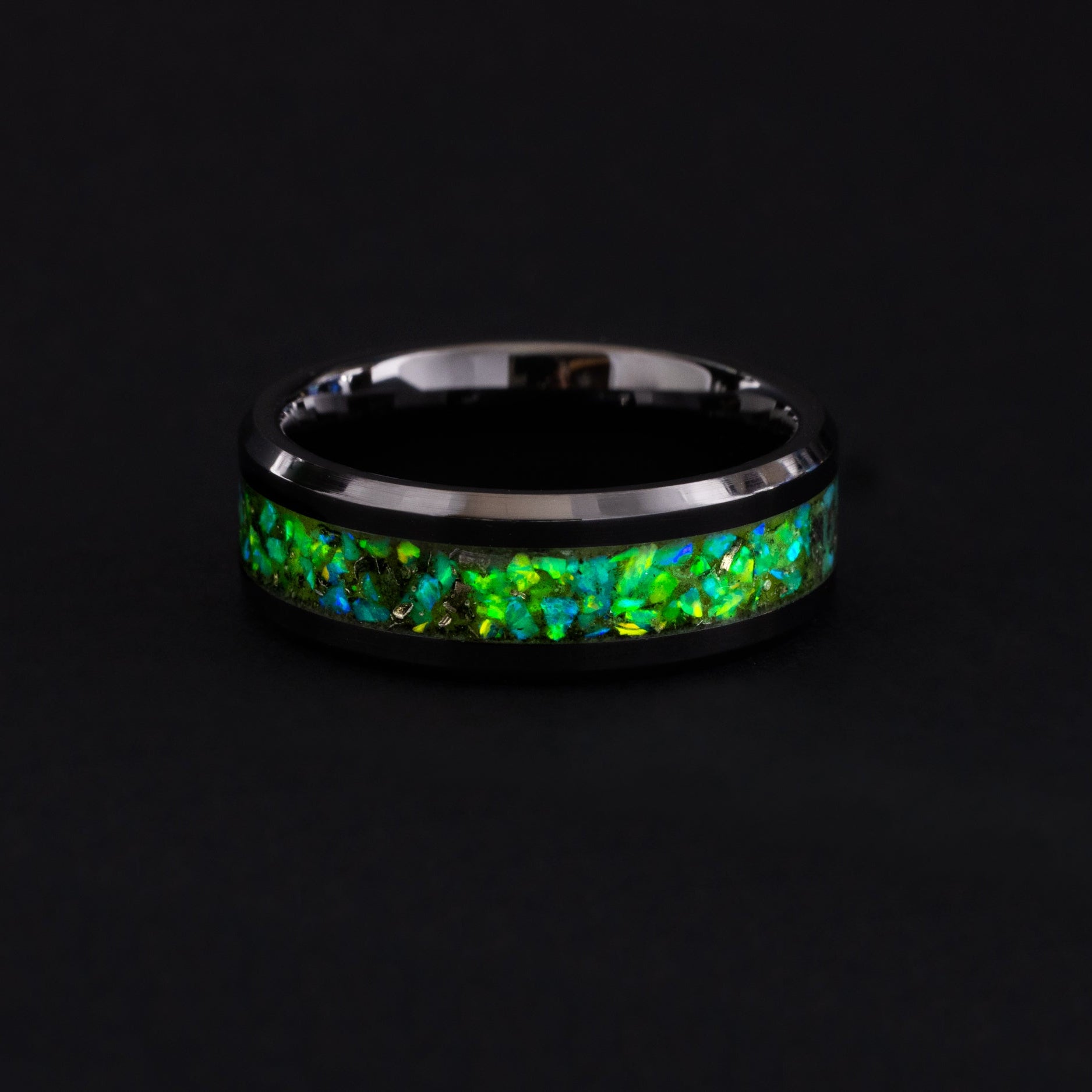 Handcrafted 8mm black ceramic wedding band featuring celestial meteorite fragments and lime green glow.