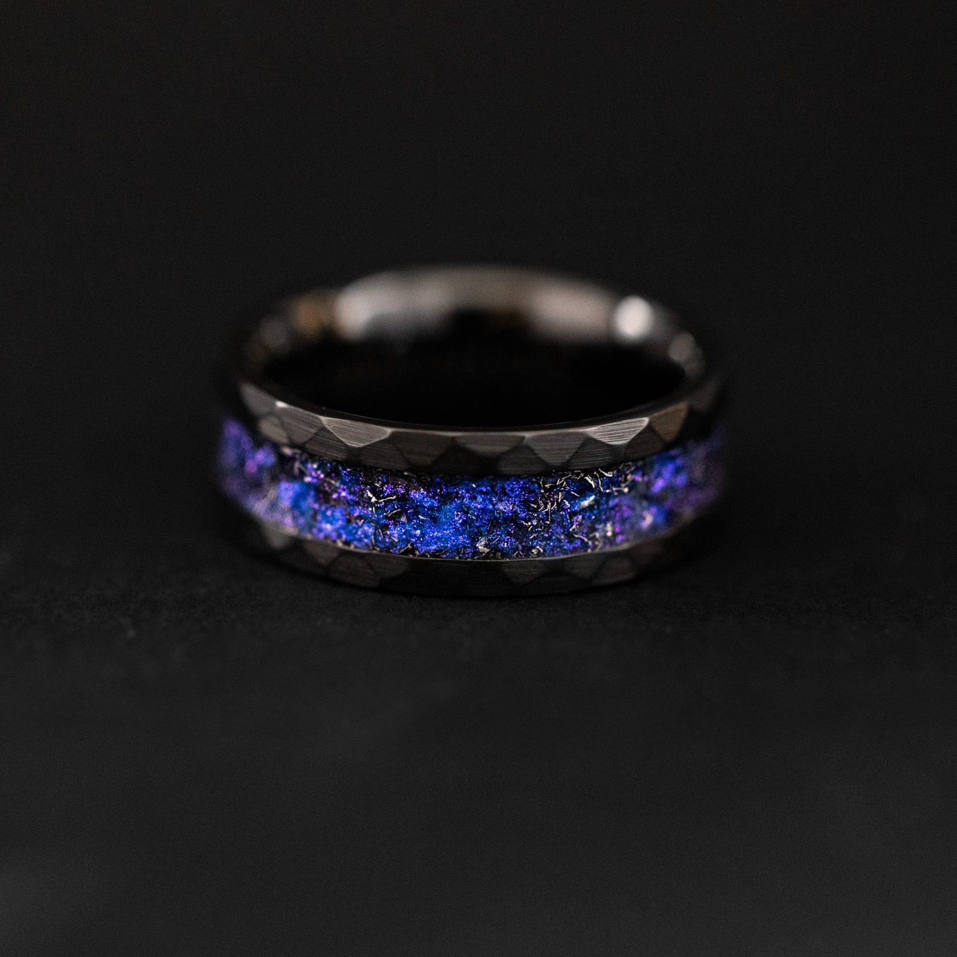 Handcrafted hammered black ceramic wedding band featuring celestial meteorite fragments and twilight shimmer.