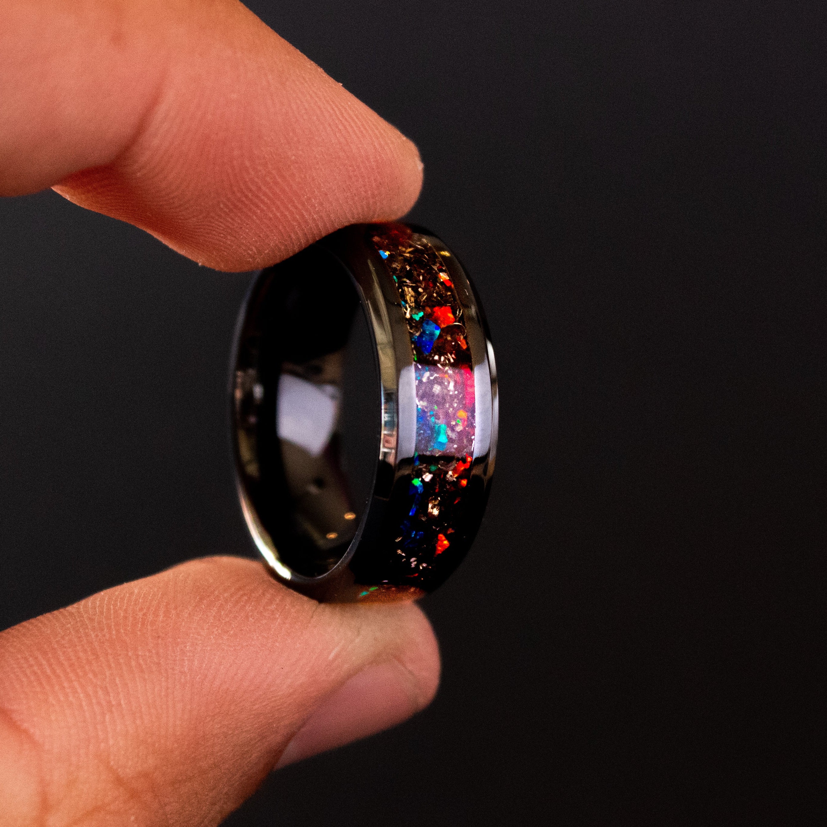 Handcrafted 8mm beveled black ceramic mens wedding band with authentic Campo del Cielo meteorite in split red and blue opal inlay made in California