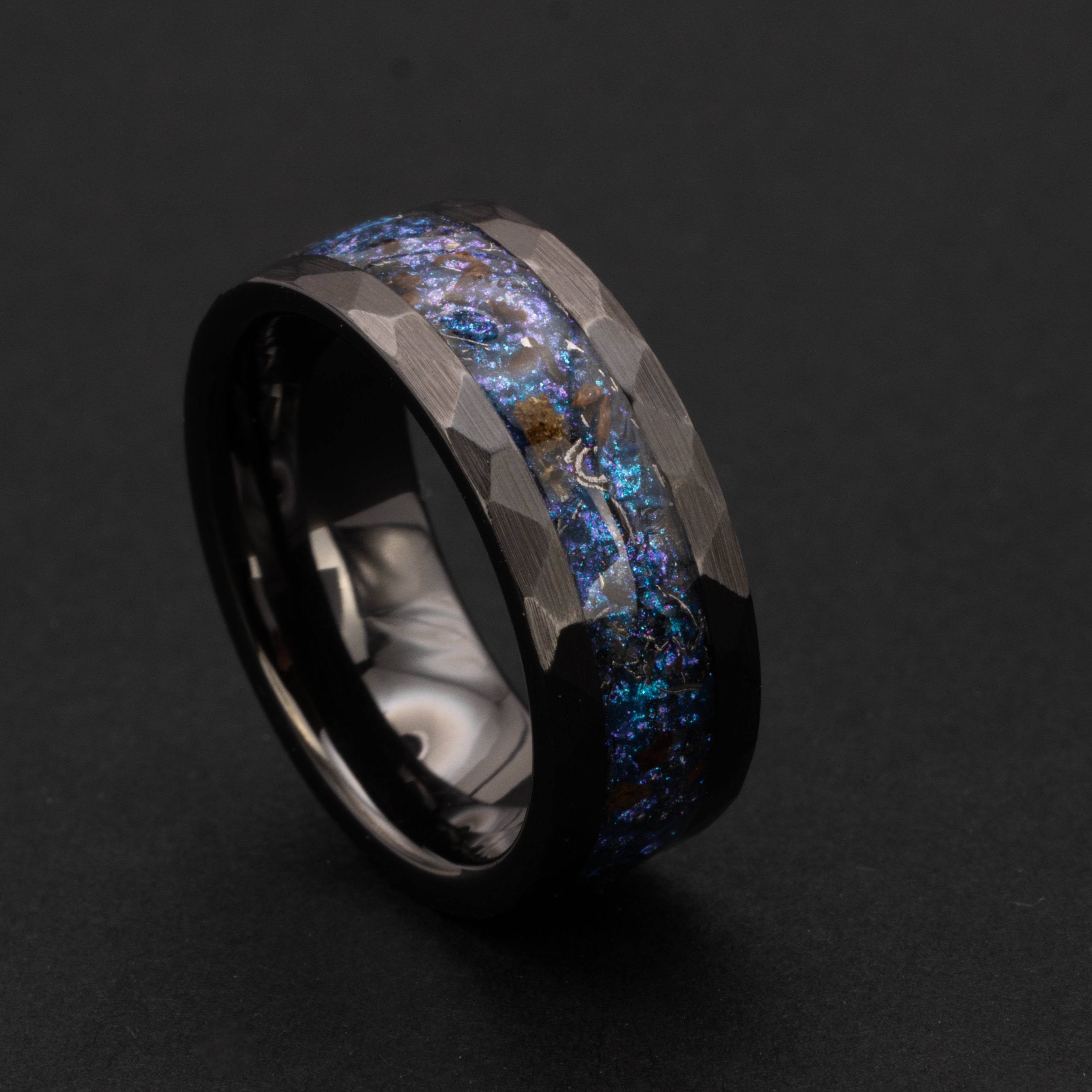 Handcrafted hammered black ceramic mens wedding band with authentic T-Rex bone and Campo del Cielo meteorite in blue and purple opal galaxy inlay made in California
