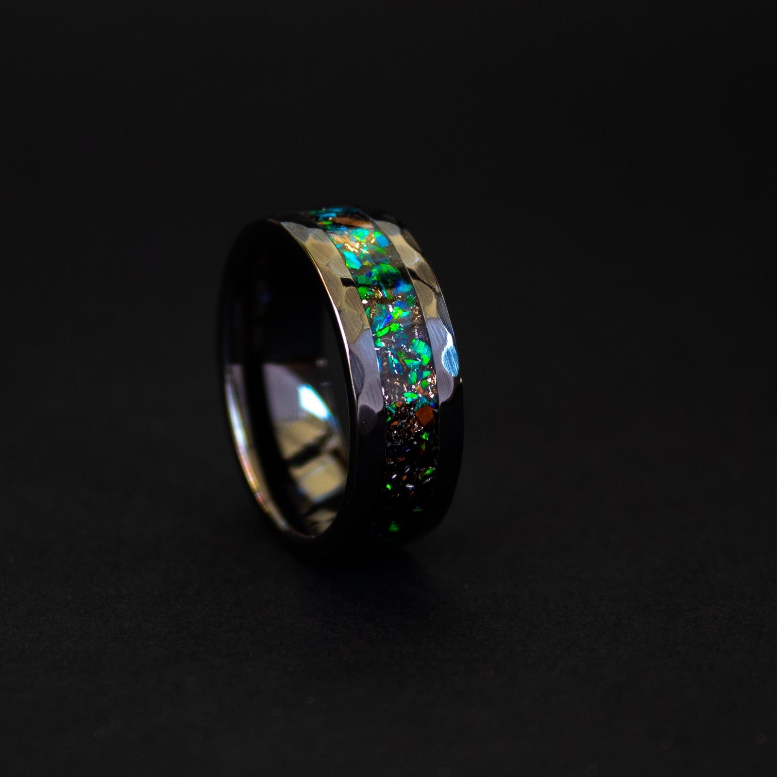 Handcrafted hammered black ceramic mens wedding band with authentic T-Rex bone and Campo del Cielo meteorite in green opal inlay made in California