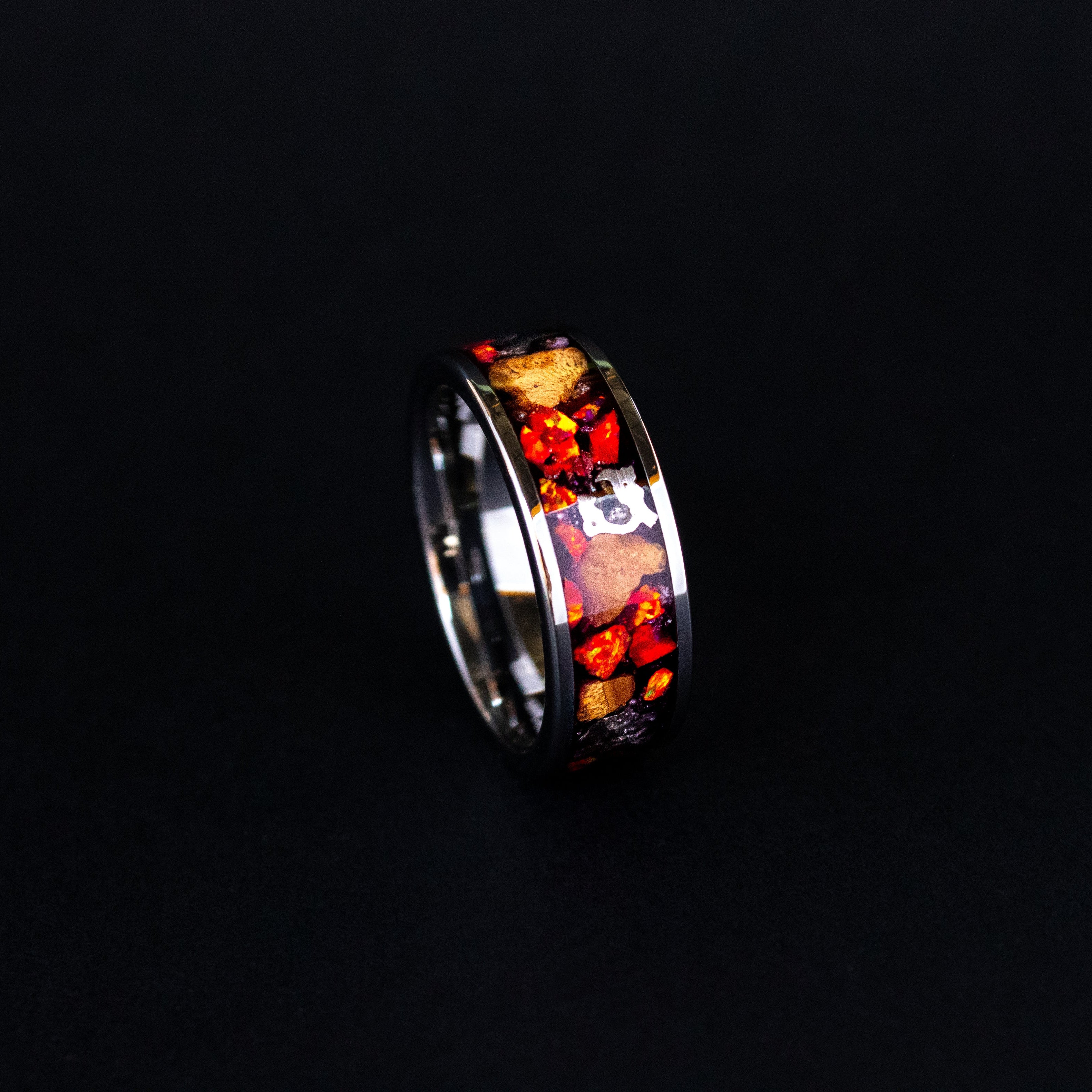Handcrafted 8mm wide channel tungsten mens wedding band with large authentic Triceratops bone and Campo del Cielo meteorite pieces in red opal inlay made in California