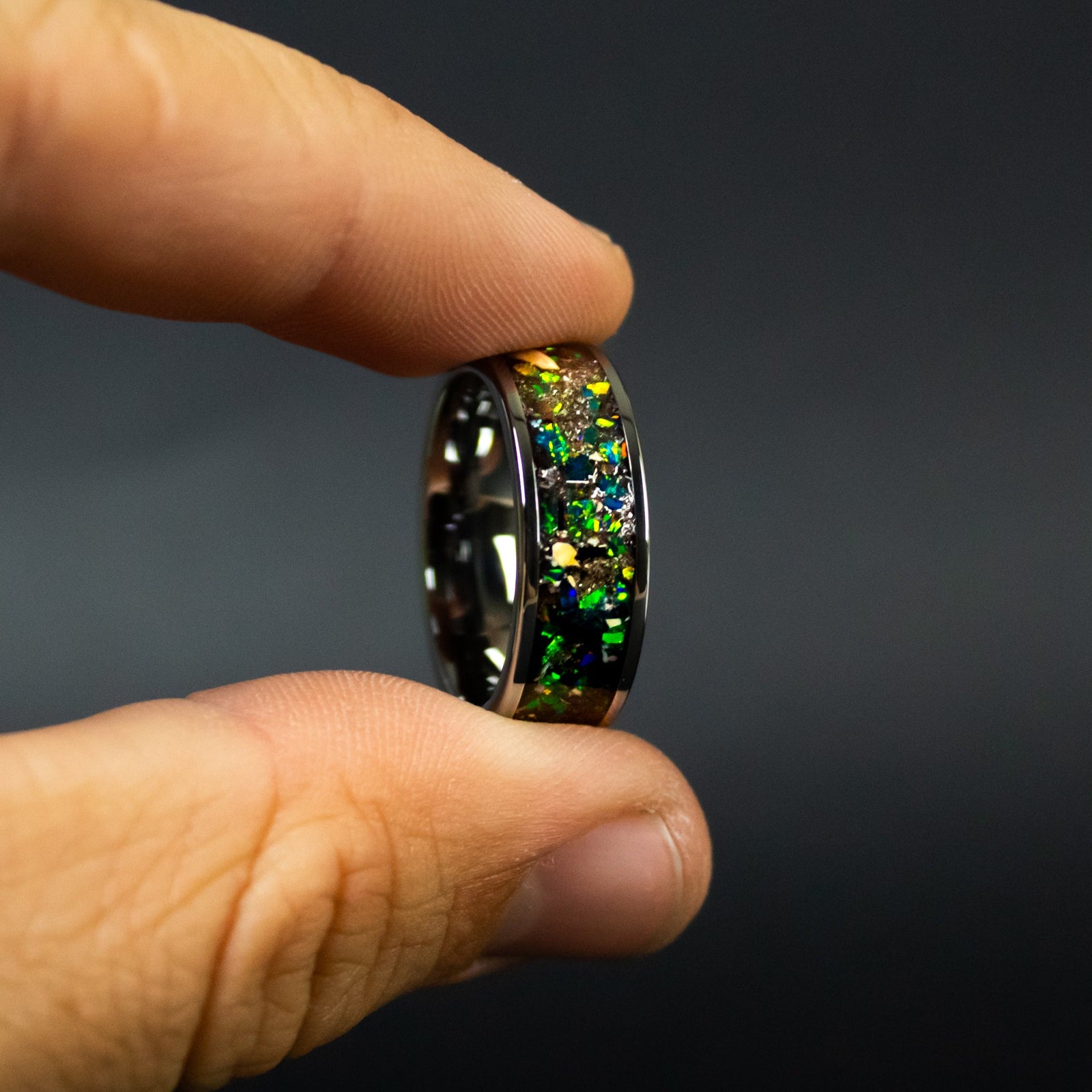 Handcrafted 8mm wide channel tungsten mens wedding band with authentic Mosasaur bone, Dinosaur Gembone, and Campo del Cielo meteorite in dark green opal inlay made in California