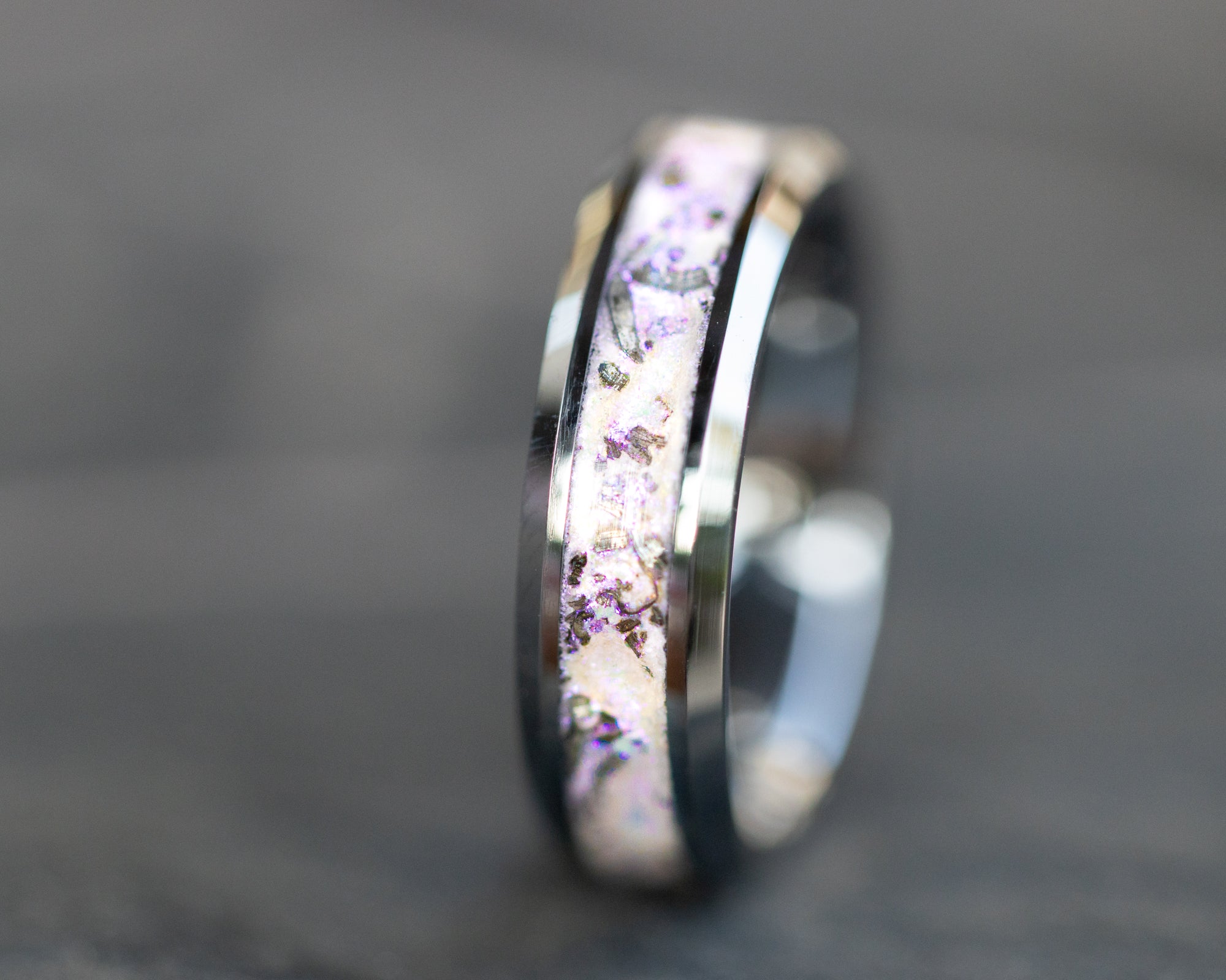 6mm beveled tungsten ring with authentic Campo del Cielo meteorite shavings suspended in white pearl glitter inlay with pink sheen